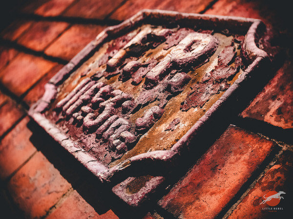 Weathered cast-iron fire point sign on the Clothworkers’ Central Building in Leeds