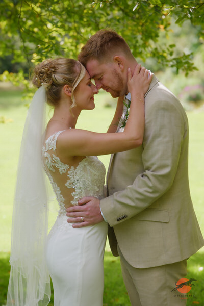 Newlyweds touching foreheads in the garden at Askham Hall near Penrith