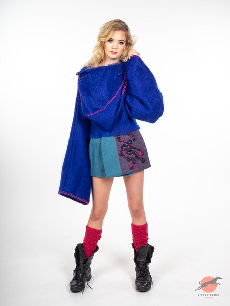 Model wearing an oversized cobalt-blue knit top and colour-block skirt during a University of Huddersfield fashion shoot