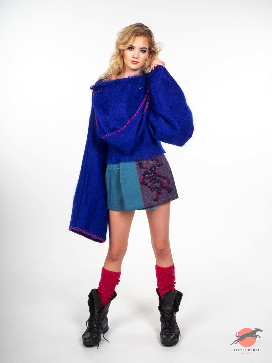 Model wearing an oversized cobalt-blue knit top and colour-block skirt during a University of Huddersfield fashion shoot