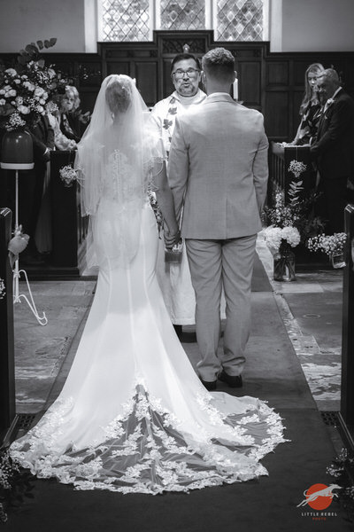 Bride and groom during their wedding ceremony at St Peter’s Church in Askham
