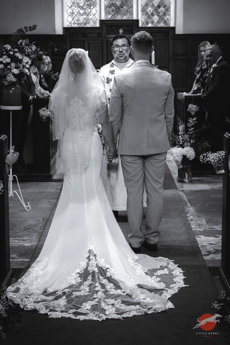 Bride and groom during their wedding ceremony at St Peter’s Church in Askham